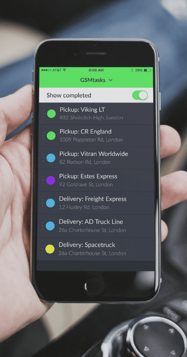 Man holding a mobile phone with open GSMtasks app