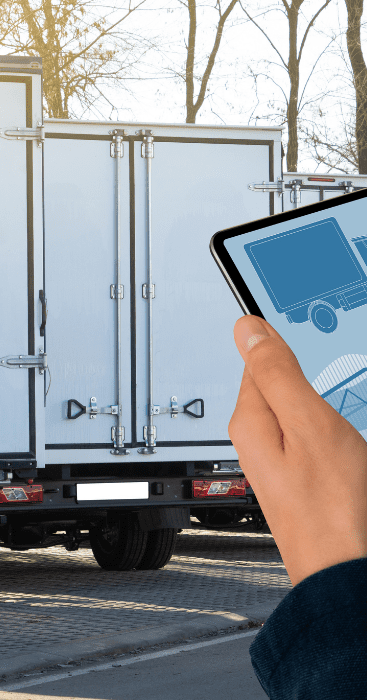 Man holding a tablet and moving trucks