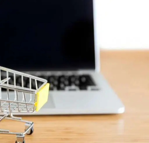 Shopping cart next to a laptop