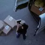 Woman counting packages on a mobile device